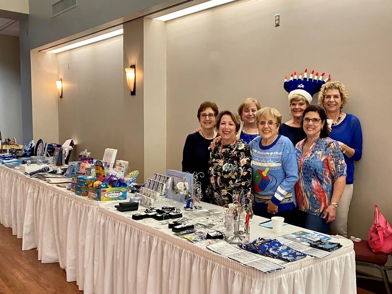 Sisterhood helping with the Judaica Shop at the Temple Hanukkah Party